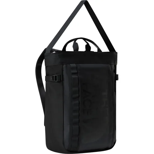The North Face 2-in-1 Base Camp Tote Pack TNF Black - Handtaschen aus strapazierfähigem Base Camp-Material, vielseitig tragbar als Shopper oder Rucksack, mit wasserabweisendem Schutz und praktischen Kompressionsriemen.